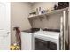 Laundry room features new washer and dryer units with storage shelf at 30876 W Verde Ln, Buckeye, AZ 85396