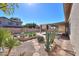 Lush backyard showcasing desert landscaping, stone pathways, and a covered patio at 309 E Mountain Sky Ave, Phoenix, AZ 85048