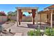 Inviting backyard patio featuring a pergola with curtains and desert landscaping at 309 E Mountain Sky Ave, Phoenix, AZ 85048