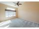 Neutral main bedroom with large windows, high ceilings, and light-colored carpet at 309 E Mountain Sky Ave, Phoenix, AZ 85048