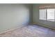 Neutral bedroom with plush carpeting, a window, and light-colored walls at 309 E Mountain Sky Ave, Phoenix, AZ 85048