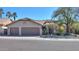 Charming home exterior featuring a three-car garage and desert landscaping at 309 E Mountain Sky Ave, Phoenix, AZ 85048