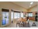 Bright kitchen nook features a round table, views of the backyard, and a kitchen with granite counters at 309 E Mountain Sky Ave, Phoenix, AZ 85048