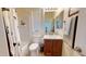 Well-lit bathroom featuring a shower-tub combo and a vanity with a tile backsplash and a dark wood finish at 33732 N Sandstone Dr, San Tan Valley, AZ 85143