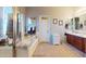 Bright bathroom featuring a soaking tub with tile surround and vanity with dark wood cabinets and tile floors at 33732 N Sandstone Dr, San Tan Valley, AZ 85143