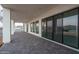 Spacious covered back patio with stamped concrete flooring, sliding glass doors and spiral staircase at 37931 N 31St Ave, Phoenix, AZ 85086