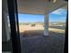 View of the backyard through a window, with mountain views in the distance at 37931 N 31St Ave, Phoenix, AZ 85086