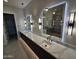 Modern bathroom featuring dual sinks, quartz countertop, large mirrors and stylish lighting fixtures at 37931 N 31St Ave, Phoenix, AZ 85086