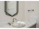 Stylish powder room featuring a unique vessel sink and a modern, geometric mirror at 37931 N 31St Ave, Phoenix, AZ 85086