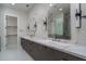 Modern bathroom featuring dual sinks, quartz countertop, and large mirrors with stylish lighting fixtures at 37931 N 31St Ave, Phoenix, AZ 85086