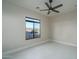 Bright bedroom featuring neutral paint, a ceiling fan, and a view of the outside at 37931 N 31St Ave, Phoenix, AZ 85086