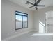 Bright bedroom featuring neutral paint, a ceiling fan, and a view of the outside at 37931 N 31St Ave, Phoenix, AZ 85086