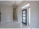 Spacious foyer featuring tile flooring, modern lighting, and a sleek front door with sidelights at 37931 N 31St Ave, Phoenix, AZ 85086