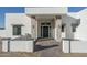 Inviting front entrance with stone pillars, a modern front door, pavers, and stylish lighting fixtures at 37931 N 31St Ave, Phoenix, AZ 85086