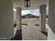 View from front door showcasing the brick paved entrance, stone columns, and desert landscaping at 37931 N 31St Ave, Phoenix, AZ 85086