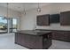 Contemporary kitchen featuring a large island and pendant lighting fixtures at 37931 N 31St Ave, Phoenix, AZ 85086