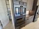 A close up view of a double oven within kitchen cabinets at 37931 N 31St Ave, Phoenix, AZ 85086