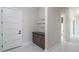 Welcoming mud room features a sleek cabinet with a dark countertop and stylish glass shelving for storage and decor at 37931 N 31St Ave, Phoenix, AZ 85086