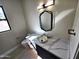 Modern powder room with a unique bowl sink and a geometric mirror at 37931 N 31St Ave, Phoenix, AZ 85086