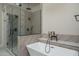 Beautiful bathroom with a modern soaking tub, walk-in shower, elegant fixtures, and geometric patterned tile at 37931 N 31St Ave, Phoenix, AZ 85086