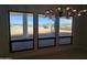 Three large picture windows offer a view of the desert, mountains, and spiral staircase at 37931 N 31St Ave, Phoenix, AZ 85086