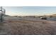 View of a large undeveloped desert backyard with block wall and a spiral staircase on home at 37937 N 31St Ave, Phoenix, AZ 85086