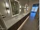 Bright bathroom showcasing a long vanity with double sinks, illuminated mirrors, and a glass-enclosed shower at 37937 N 31St Ave, Phoenix, AZ 85086