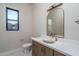 Well-lit bathroom featuring decorative sink, modern mirror, and neutral color palette at 37937 N 31St Ave, Phoenix, AZ 85086