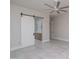 Bright bedroom with barn door access to the ensuite bathroom at 37937 N 31St Ave, Phoenix, AZ 85086