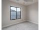 Neutral bedroom with a ceiling fan and a large window providing natural light and views at 37937 N 31St Ave, Phoenix, AZ 85086