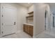 Entryway featuring built-in cabinets, floating wood shelves, and neutral walls at 37937 N 31St Ave, Phoenix, AZ 85086