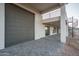 Modern home's exterior featuring a large garage door, second-story patio, and spiral staircase at 37937 N 31St Ave, Phoenix, AZ 85086