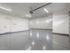 Large garage with epoxy flooring, white walls, and overhead lighting at 37937 N 31St Ave, Phoenix, AZ 85086