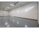 Spacious garage with painted floors and walls plus multiple access doors and windows at 37937 N 31St Ave, Phoenix, AZ 85086