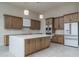 Modern kitchen with quartz island, white backsplash, and stainless-steel appliances at 37937 N 31St Ave, Phoenix, AZ 85086