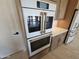 Close-up view of high-end, stainless steel double ovens at 37937 N 31St Ave, Phoenix, AZ 85086