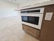 Detail of kitchen island with built-in microwave at 37937 N 31St Ave, Phoenix, AZ 85086