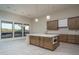 Bright kitchen showcasing a large island with a waterfall edge and modern appliances at 37937 N 31St Ave, Phoenix, AZ 85086