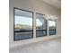 Bright living room features large windows with mountain views and a decorative chandelier at 37937 N 31St Ave, Phoenix, AZ 85086