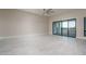 Large living room with tile floors, sliding glass doors to patio, and neutral color palette at 37937 N 31St Ave, Phoenix, AZ 85086