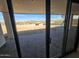 View from patio doors showing a desert backyard and view of distant mountains at 37937 N 31St Ave, Phoenix, AZ 85086