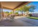 Covered patio with dining set and putting green overlooking the backyard at 4266 E Cassia Ln, Gilbert, AZ 85298