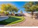 Lush backyard with putting green, decorative rock, and a water feature at 4266 E Cassia Ln, Gilbert, AZ 85298