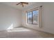 Bright bedroom with large window offering natural light and neutral colored carpet at 4266 E Cassia Ln, Gilbert, AZ 85298