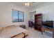 Cozy bedroom with a daybed, built-in desk, and a large window with natural light at 4266 E Cassia Ln, Gilbert, AZ 85298