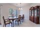 Elegant dining room with a wooden table set, chandelier lighting, and marble flooring at 4266 E Cassia Ln, Gilbert, AZ 85298