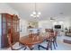 Open concept dining room with tile floors, wooden furniture, and a view of the kitchen and living area at 4266 E Cassia Ln, Gilbert, AZ 85298