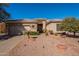 Charming single-story home featuring a desert landscape, tile roof, and a two-car garage at 4266 E Cassia Ln, Gilbert, AZ 85298