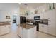 Bright kitchen features a center island, granite countertops and white cabinetry at 4266 E Cassia Ln, Gilbert, AZ 85298