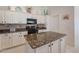 Well-equipped kitchen with granite countertops, white cabinetry, and modern appliances at 4266 E Cassia Ln, Gilbert, AZ 85298